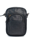 Mini camera bag in dark leather with zip closure and front pocket, featuring an adjustable strap for easy carrying.