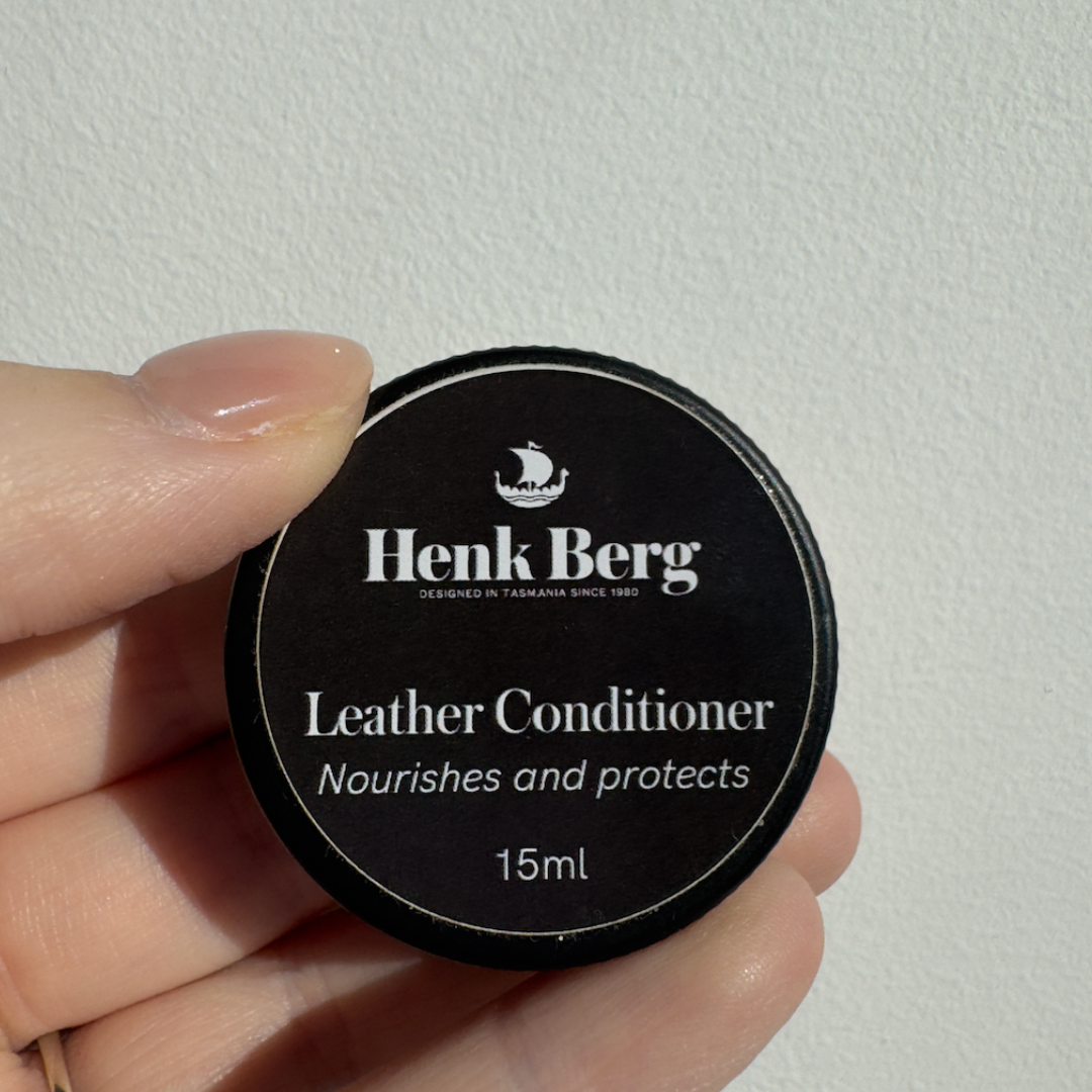 Henk Berg Leather Conditioner in a black container, nourishing and protecting leather, ideal for leather purses.