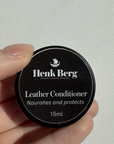 Henk Berg Leather Conditioner in a black container, nourishing and protecting leather, ideal for leather purses.